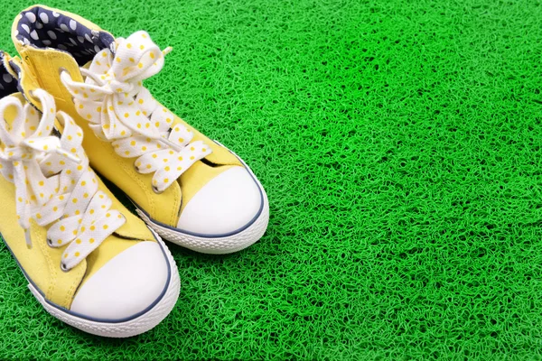 Sneakers on green carpet background — Stock Photo, Image