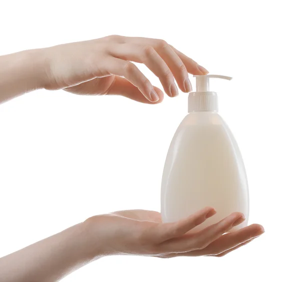 Vrouwelijke handen met cosmetica fles geïsoleerd op wit — Stockfoto