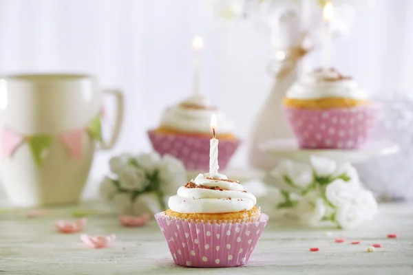 Delicious birthday cupcakes on table on light background — Stock Photo, Image