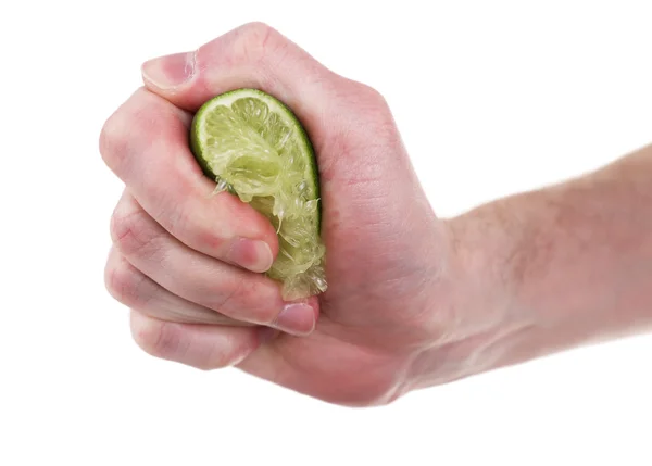 Kvinnlig hand klämma lime isolerad på vit — Stockfoto