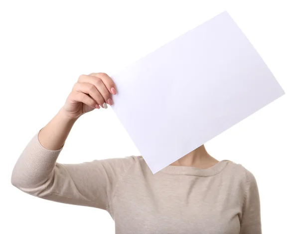 Woman covering her face with blank sheet of paper isolated on white — Stock Photo, Image