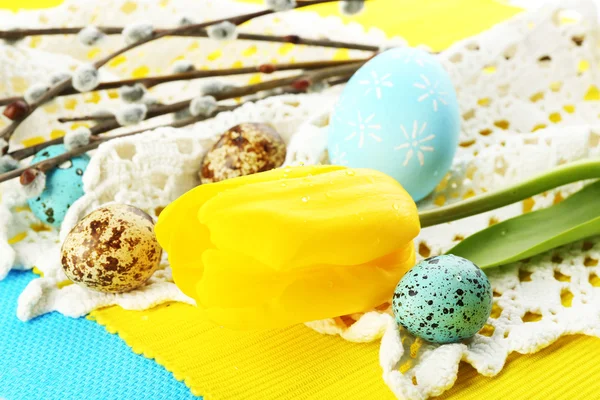 Yellow tulip, colorful eggs and napkins, close-up — Stock Photo, Image