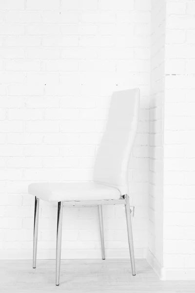 Modern chair on white brick wall background — Stock Photo, Image