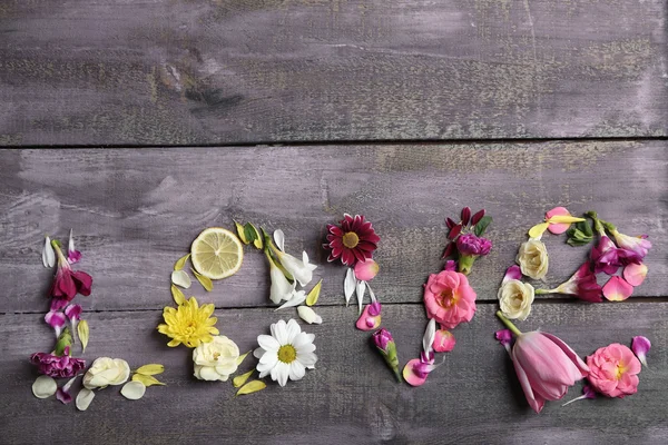 Smile of beautiful flowers, on wooden table — Stock Photo, Image