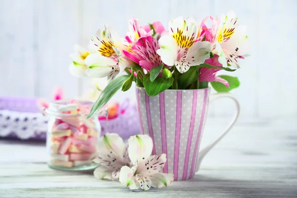 Beautiful flowers in cup — Stock Photo, Image