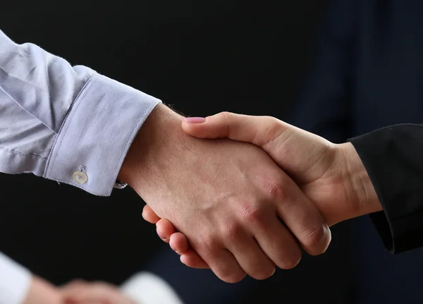 Business handshake on dark background — Stock Photo, Image