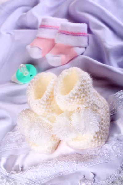 White baby boots on cloth close-up — Stock Photo, Image