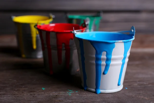 Metal buckets with colorful paint — Stock Photo, Image