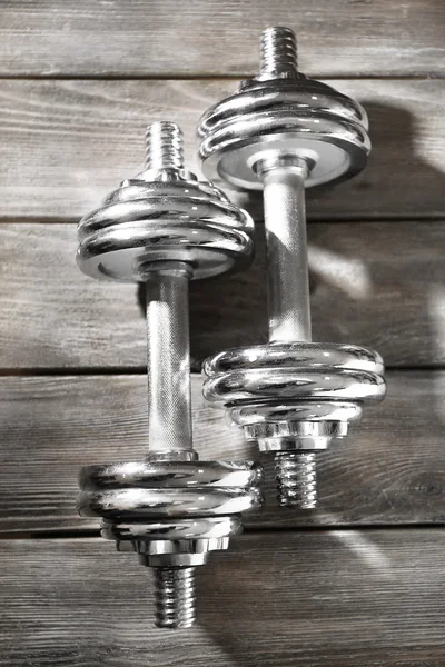 Big dumbbells on wooden background — Stock Photo, Image