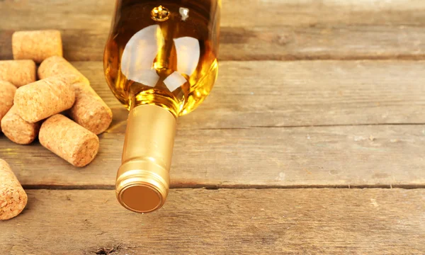 Glass bottle of wine with corks — Stock Photo, Image