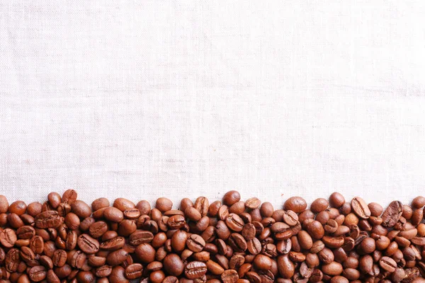 Frame of coffee beans on sackcloth background — Stock Photo, Image