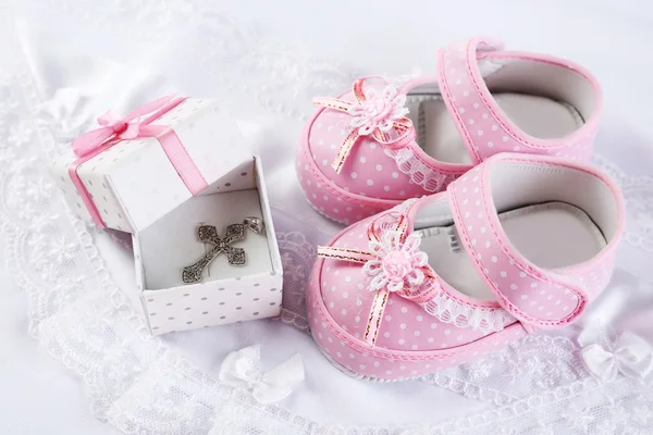 Baby shoes and cross — Stock Photo, Image