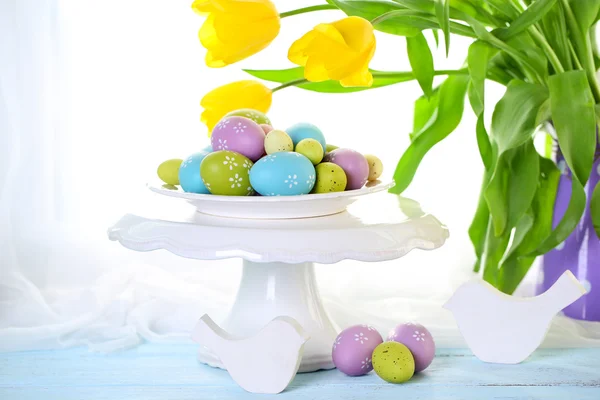 Easter eggs on vase and tulips — Stock Photo, Image