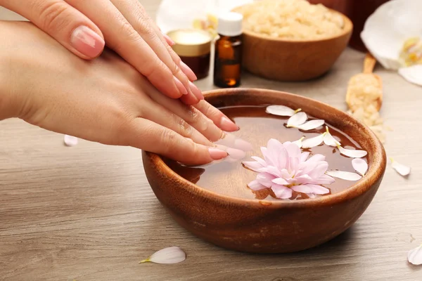 Female hands with bowl of spa water — Stock Photo, Image