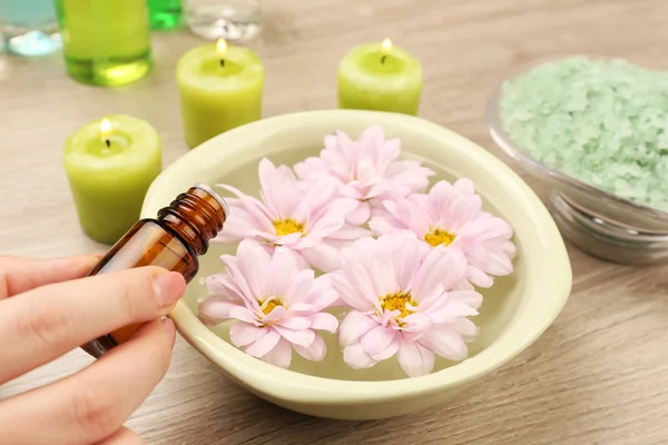 Female hand with bottle of essence — Stock Photo, Image