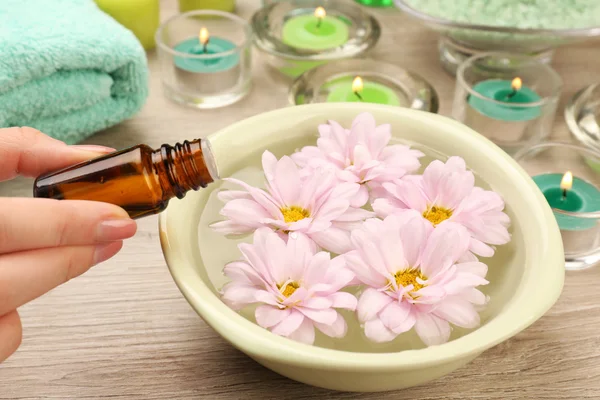 Female hand with bottle of essence — Stock Photo, Image