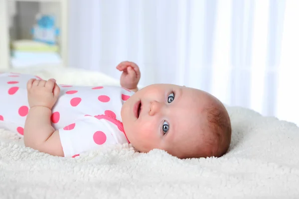 Cute baby girl, on white plaid background — Stock Photo, Image