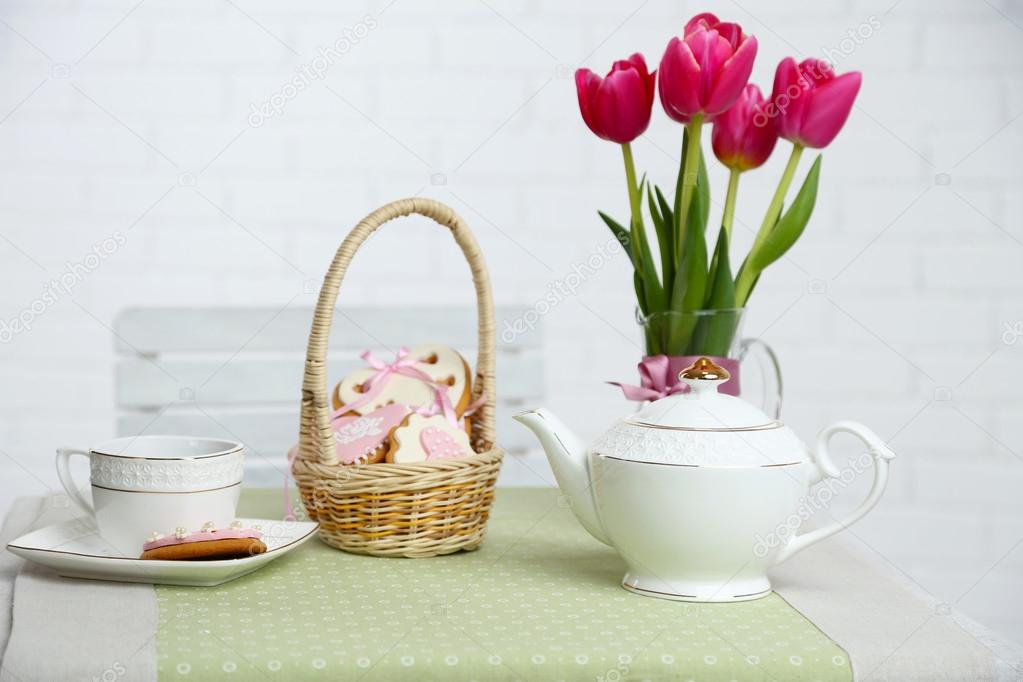 Tea set with flowers on table