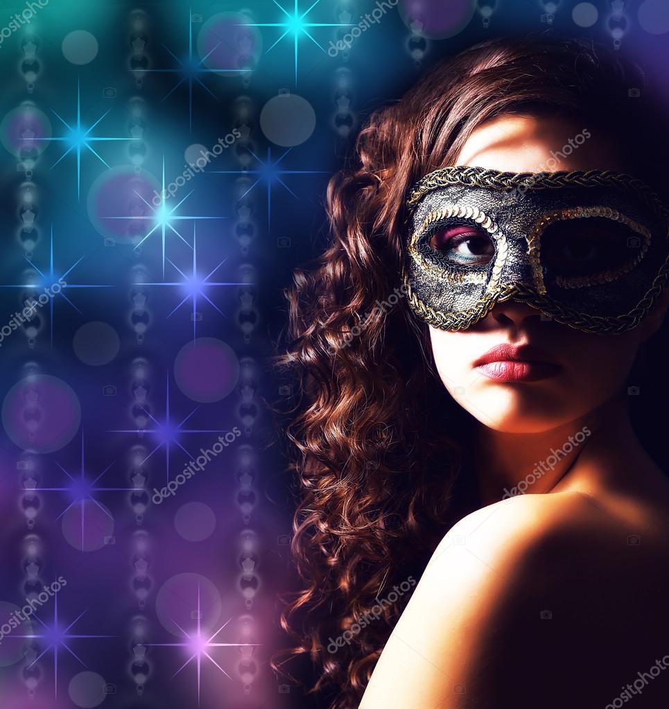 Beautiful girl with masquerade mask on lights background Stock Photo by