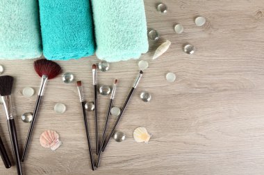 Havlu ve fırçalar ahşap arka plan üzerinde güzel kompozisyonu