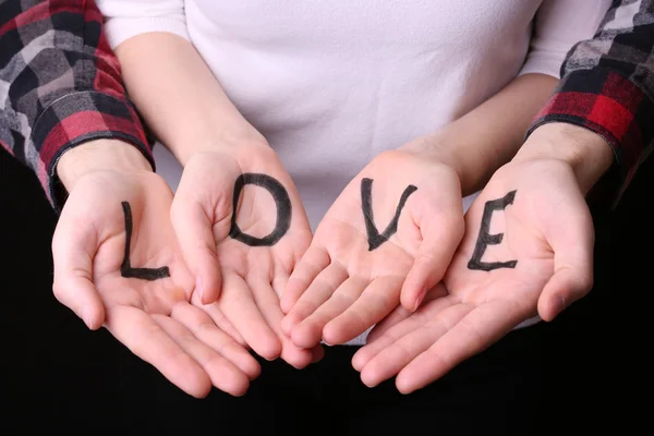 Hands of couple with inscription Love, close-up — Stock Photo, Image