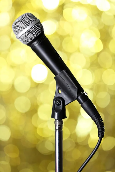 Microphone on stand on golden background — Stock Photo, Image