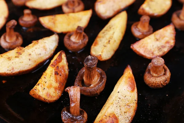 Las patatas cocidas con las setas y las especias en la cacerola se acercan —  Fotos de Stock