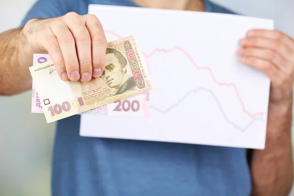 Man bedrijf geld en grafiek document sluiten van — Stockfoto