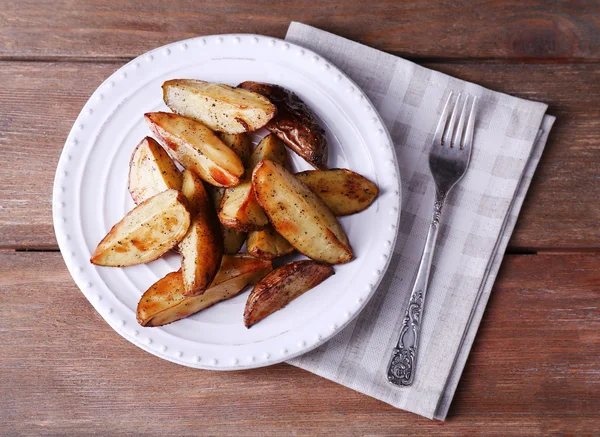 Baked potatoes on pate on wooden table — Stock Photo, Image