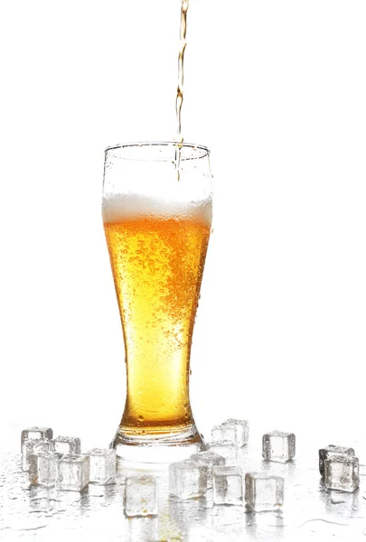 Verter cerveza en un vaso aislado sobre blanco — Foto de Stock