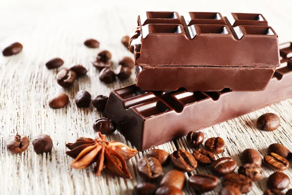 Stuffed chocolate with coffee beans on wooden table, closeup — Stock Photo, Image