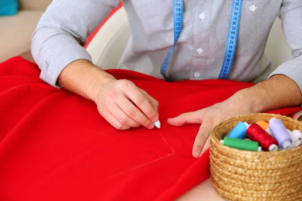 Male dressmaker tailor fabric on table — Stock Photo, Image