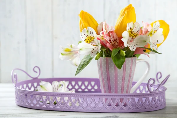 Beautiful flowers in cup — Stock Photo, Image