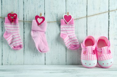 Cute toddler shoes on wooden background