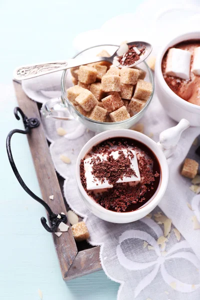 Hot chocolate with marshmallows in mug, on tray, on color wooden background — Stock Photo, Image