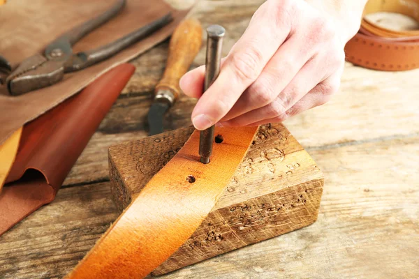 Repairing leather belt in workshop — Stock Photo, Image