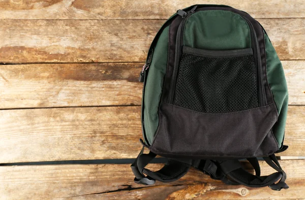 Backpack on wooden background — Stock Photo, Image