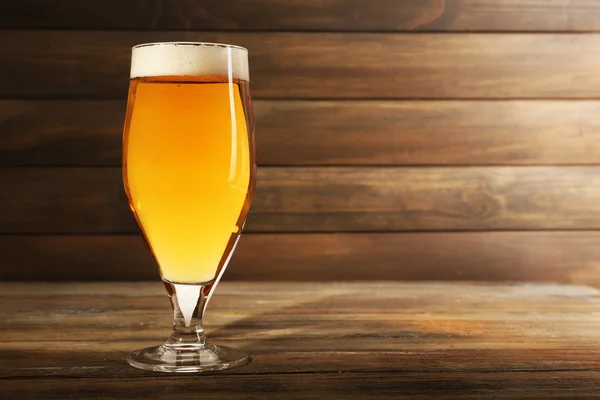 Glass of beer on wooden background — Stock Photo, Image