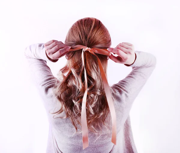 Peinado femenino con cinta de color sobre fondo de pared blanco —  Fotos de Stock