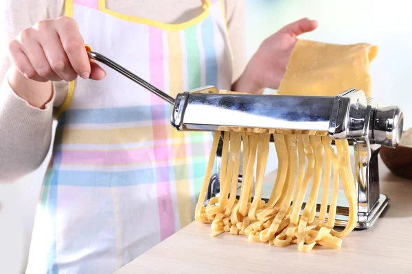 Woman making noodles with pasta machine, closeup — Stock Photo, Image