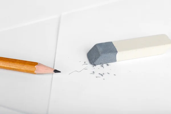 Eraser and pencil on paper background — Stock Photo, Image