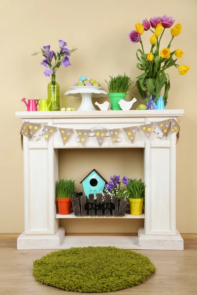 Fireplace with beautiful spring decorations in room — Stock Photo, Image
