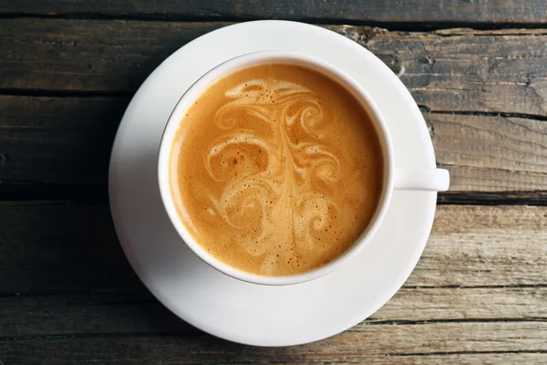 Secangkir kopi latte art di atas meja kayu, pemandangan atas — Stok Foto