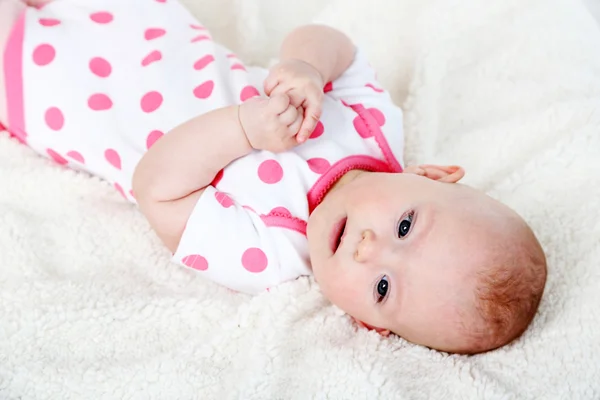 Cute baby girl, on white plaid background — Stock Photo, Image