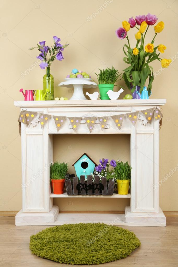 Fireplace With Beautiful Spring Decorations In Room Stock Photo