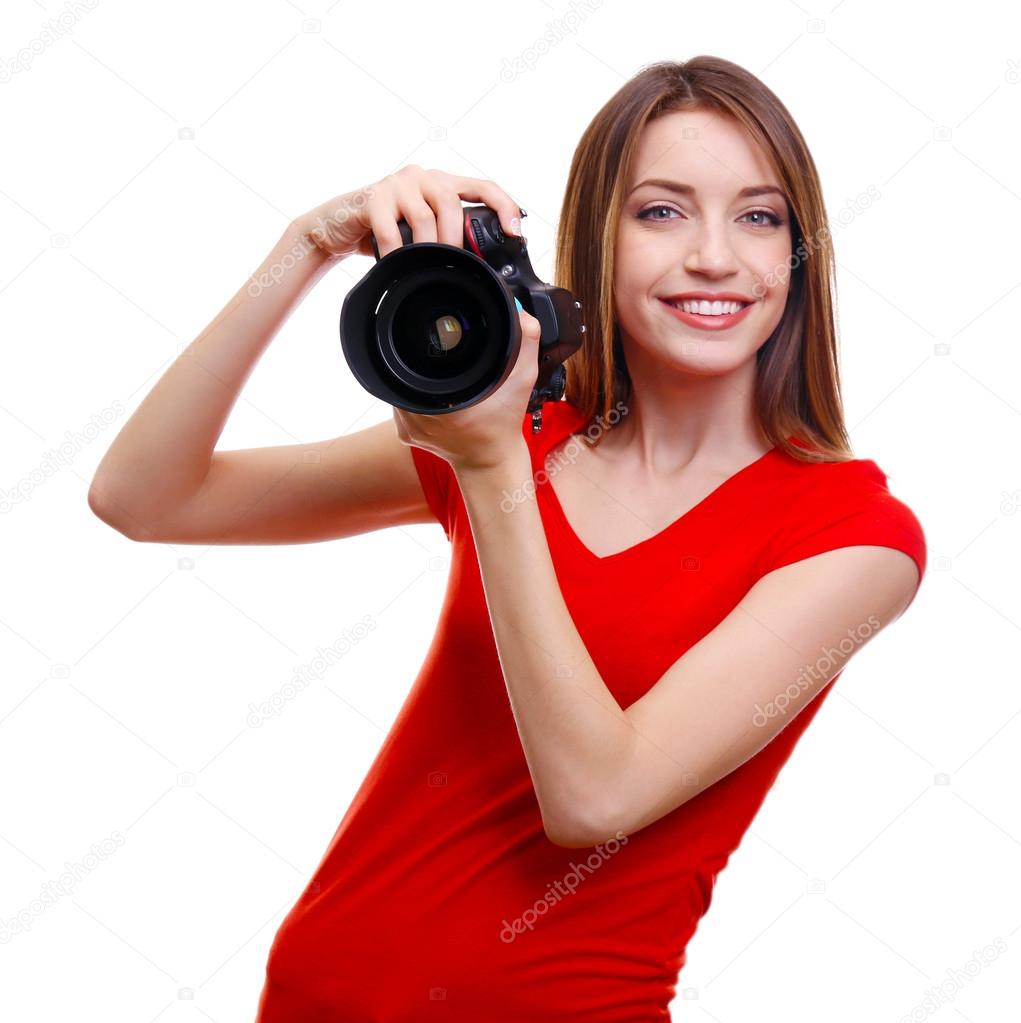 Young female photographer taking photos isolated on white