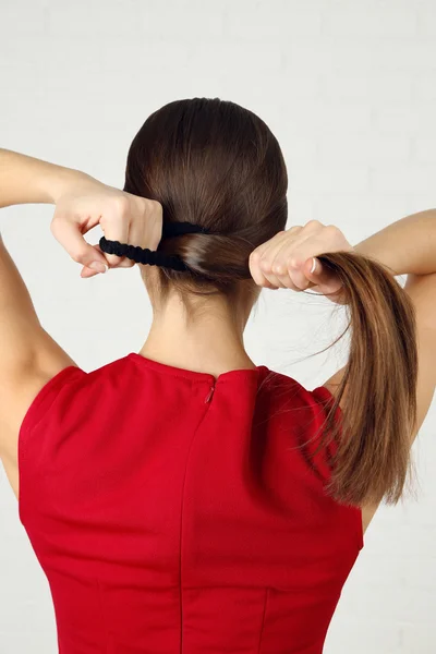 Female hairstyle on light background — Stock Photo, Image