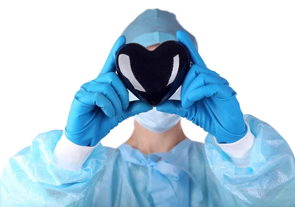 Médico segurando coração decorativo no fundo de luz — Fotografia de Stock