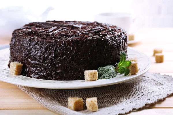 Tasty chocolate cake with cup of tea on table close up — Stock Photo, Image