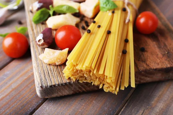 Raw pasta with cheese and vegetables on table close up — Stock Photo, Image